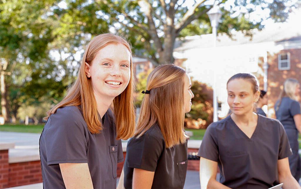 Nursing students sitting outside